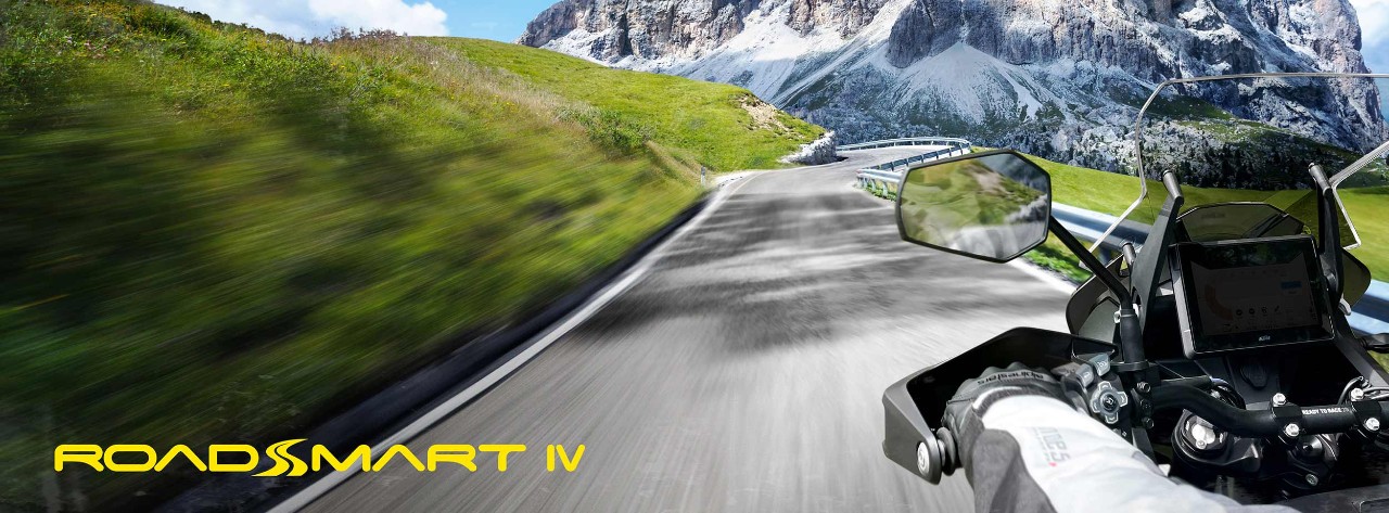 Rider on RoadSmart IV tyres riding through the Dolomites valley. Northern italy.